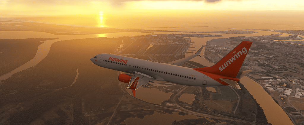Sunwing airplane flying over scenic landscape at sunset during flight simulation showcase.