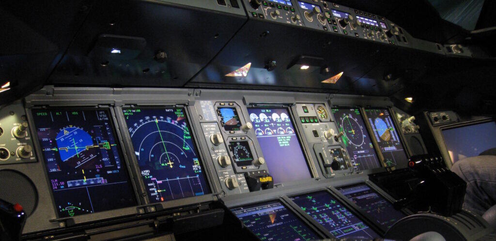 Flight simulation cockpit with advanced avionics and instrument panels.
